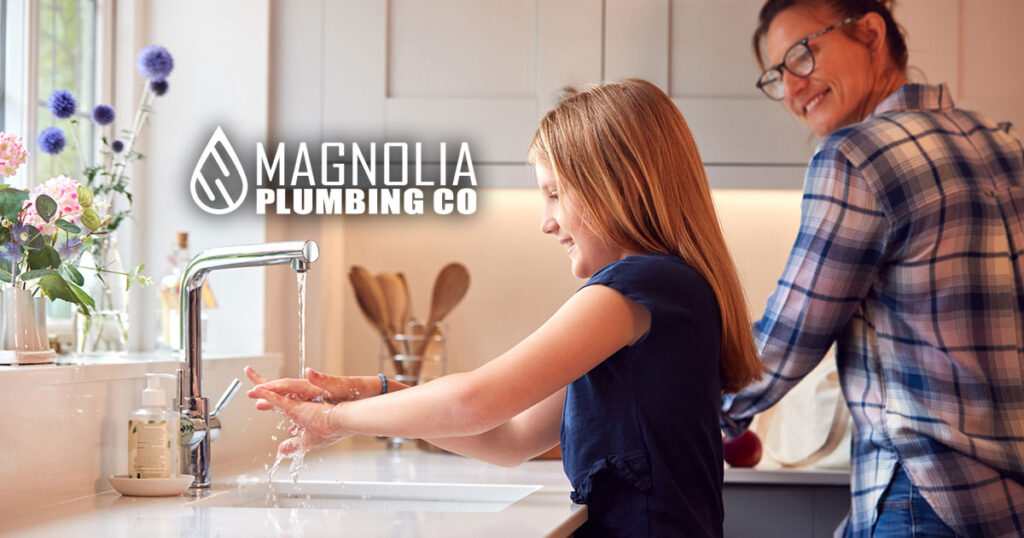 Mother With Daughter Washing Hands With Soap At Home. Faucet was installed by Complete Plumbing Services in Memphis.