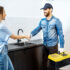 Memphis plumber shaking hands with a young woman client after the repairment on the kitchen.