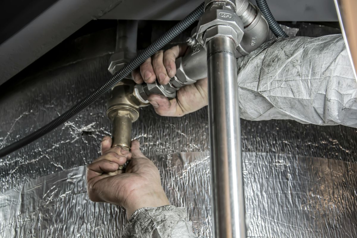 plumber installing pipe fittings