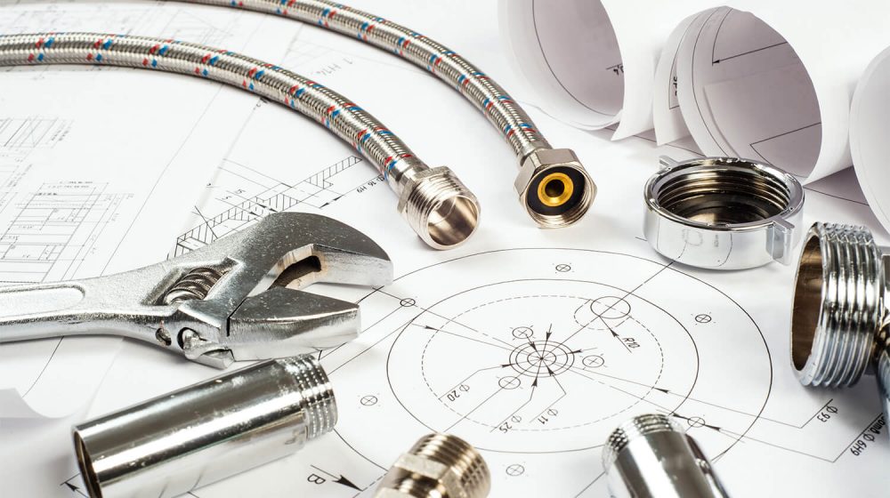 mechanical drawing plans, water lines, bolts, wrench and tools used in plumbing help and plumber services in Memphis, TN.